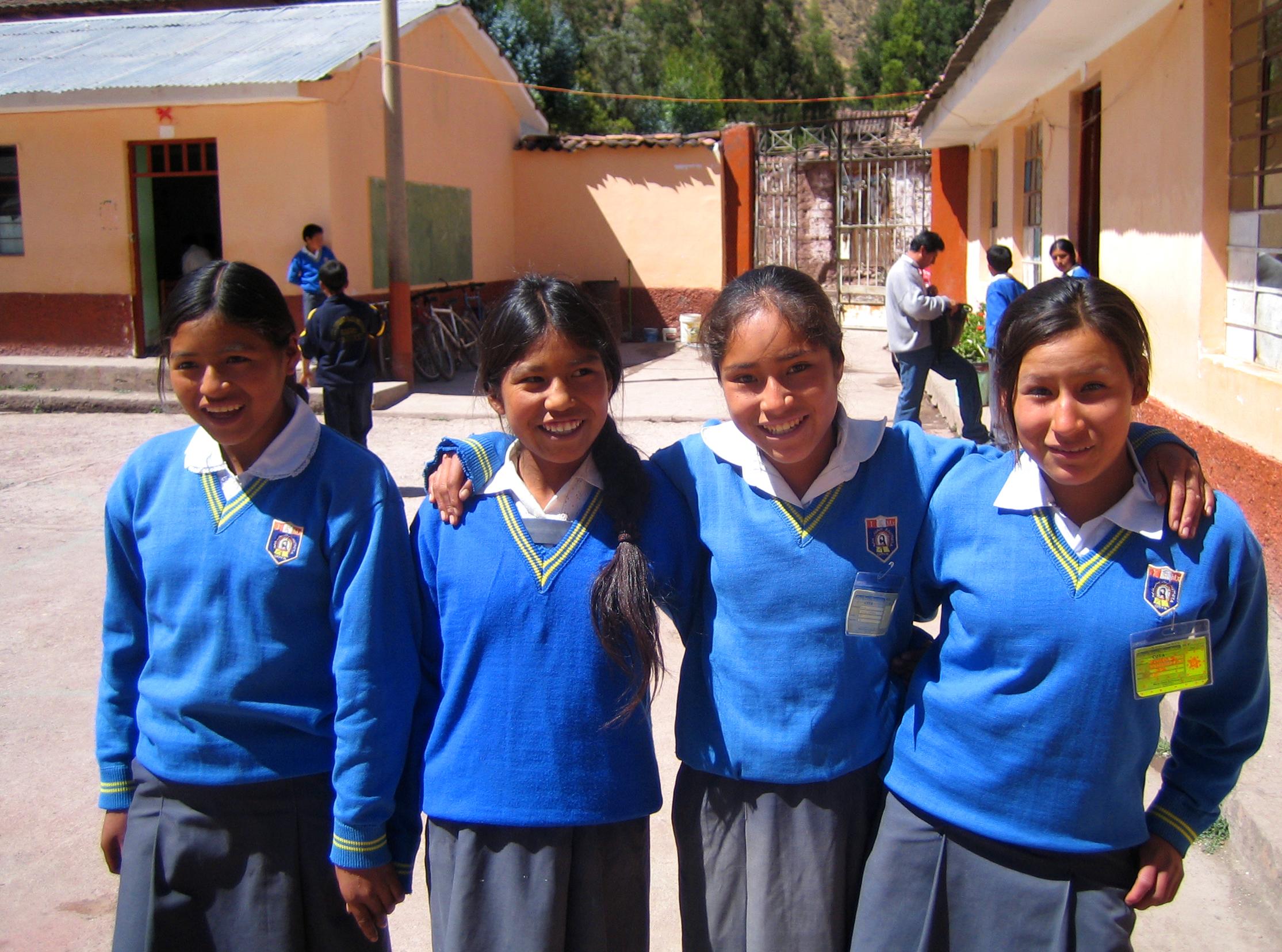 Four students from our volunteer Teaching Project in Peru A group of girls pose for a photo outside our volunteer teaching placements in Peru